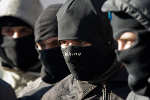 Members of the radical group Pravy Sektor (Right Sector) listen to their instructor as they practice street fighting in central Kiev, Ukraine, Monday, Feb. 3, 2014. Ukraine's president will return Monday from a short sick leave that had sparked a guessing game he was taking himself out of action in preparation to step down or for a crackdown on widespread anti-government protests. (AP Photo/Darko Bandic